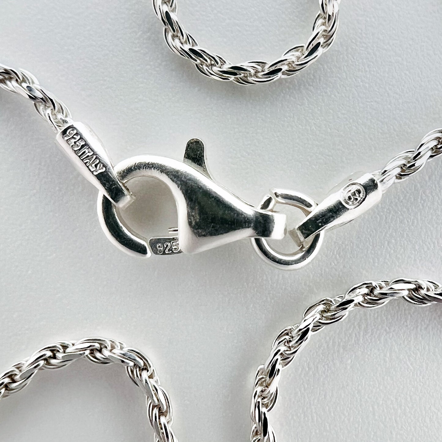 close up of clasp with 925 silver stamp and clear pattern of rope style chain is visible
