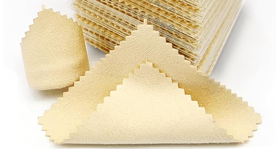 one stack of yellow polishing cloths. There is one single cloth in front of the pile showing the texture of the mirco fiber.