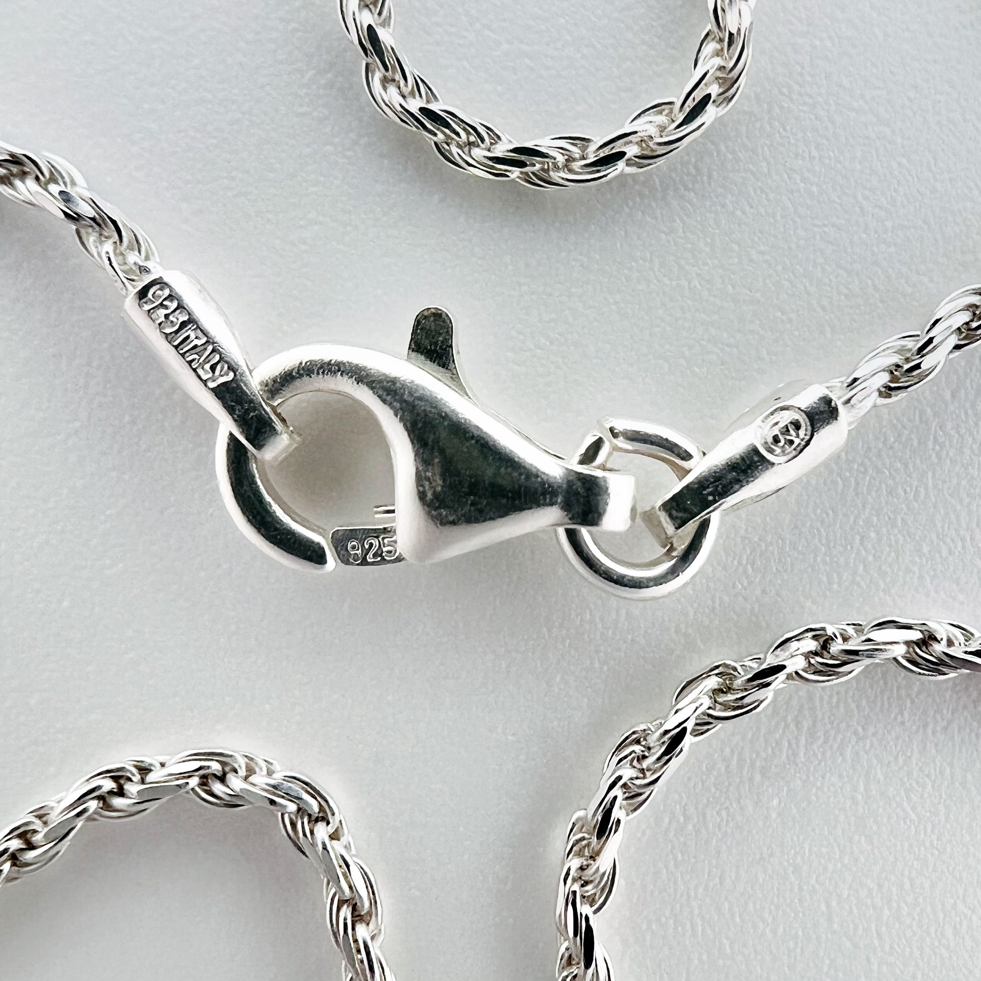 close up of clasp with 925 silver stamp and clear pattern of rope style chain is visible