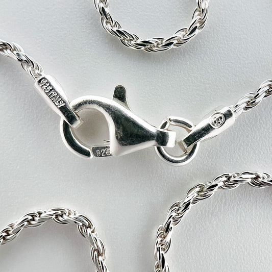 close up of clasp with 925 silver stamp and clear pattern of rope style chain is visible