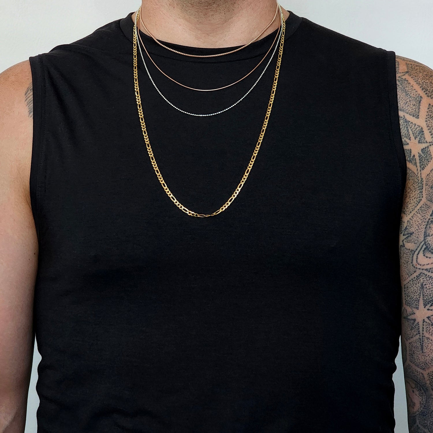 man, size medium, wearing chains in four lengths and four different styles to show where they fall. 
