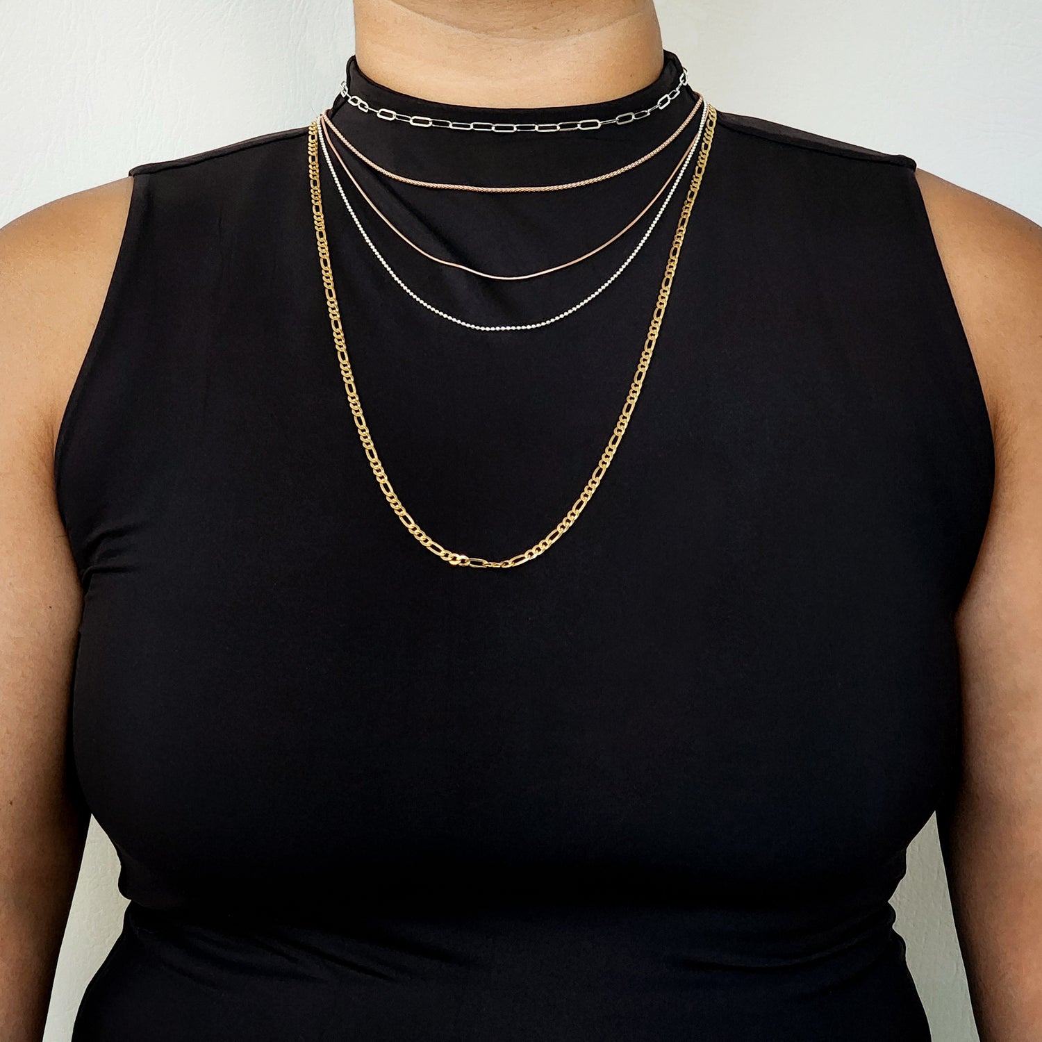 woman, size large, wearing chains in five lengths and five different styles to show where they fall. 