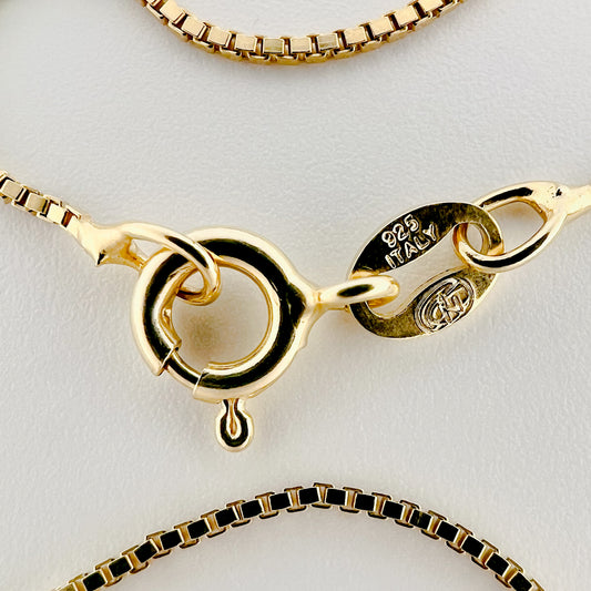 close up of clasp with 925 silver stamp and clear pattern of box style chain is visible