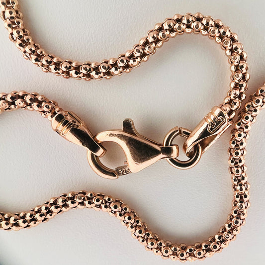 close up of clasp with 925 silver stamp and clear pattern of popcorn style chain is visible