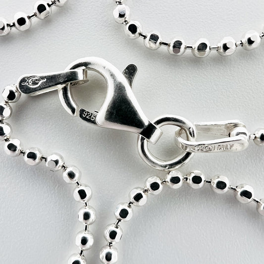 close up of closure with 925 silver stamp and clear pattern of ball style chain